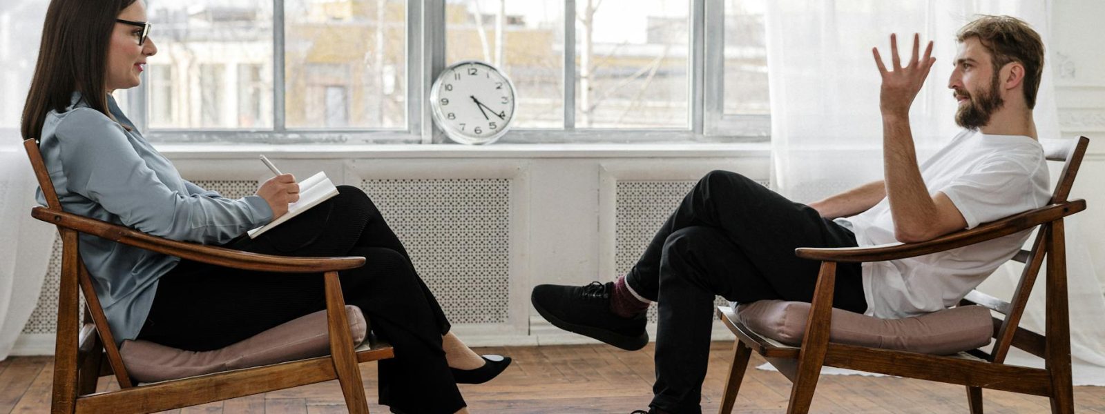ai-driven job cuts, job loss, psychology, inclusive workplace, global talent, payroll management, work arrangements, infinity8, Ouch!, HR Tech, soft skills, coaching, person in black pants and black shoes sitting on brown wooden chair