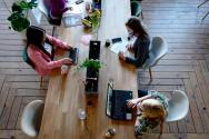 University-Industry Gap, wages, unemployment rate dropped, ai skilling, three woman sitting on white chair in front of table